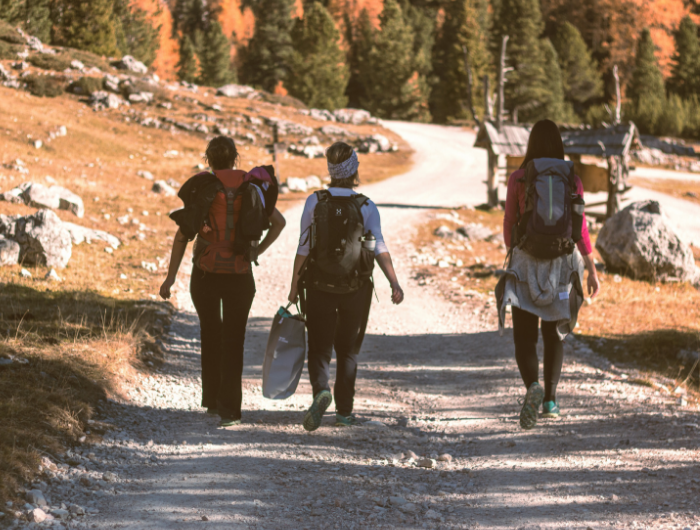 Group of three young people walking with expedition gear