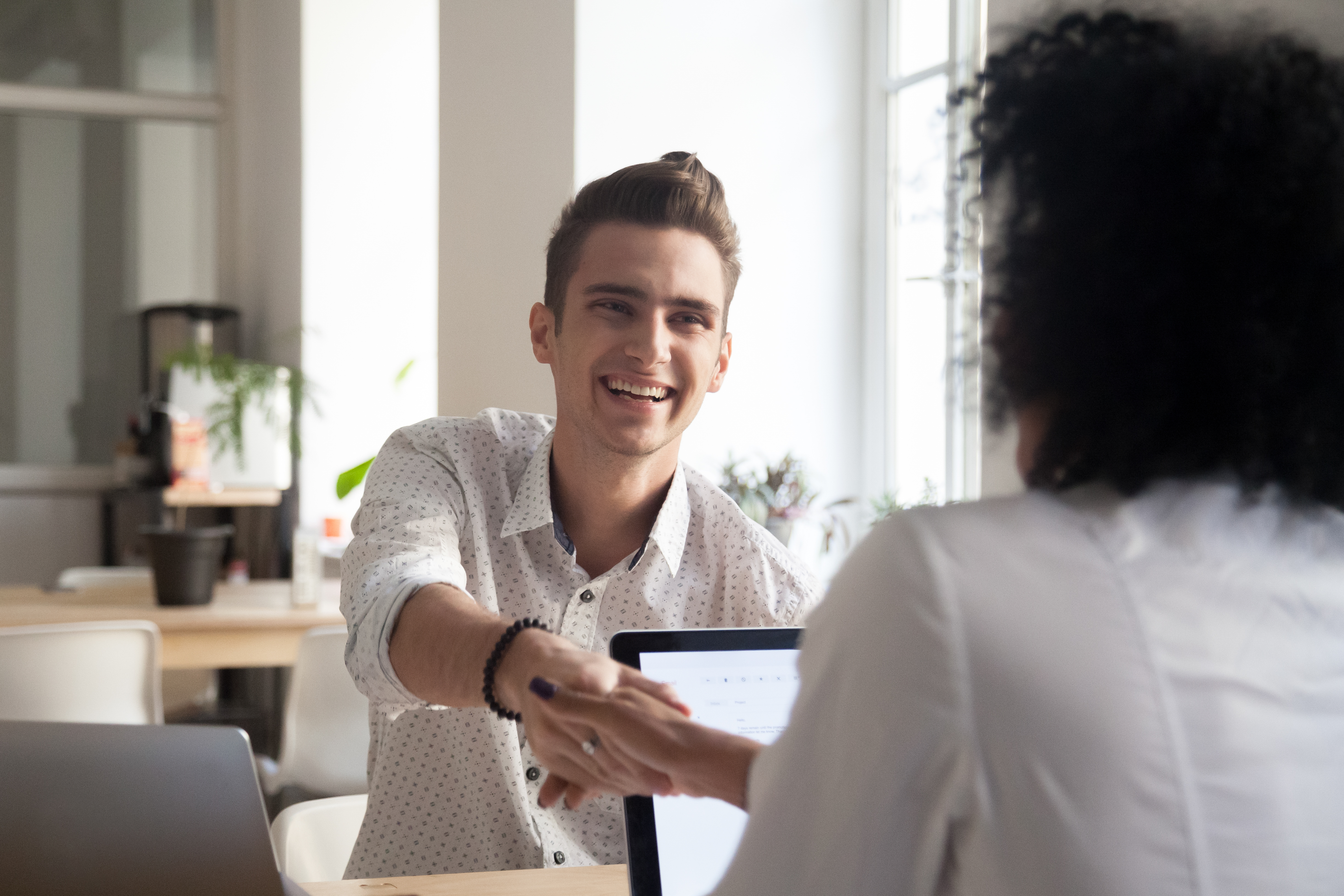 Young man at interview shaking hands