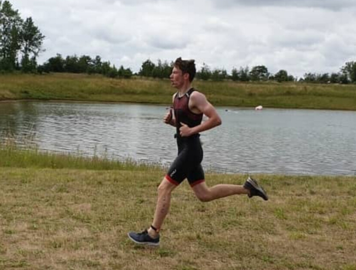 Connor running by a lake