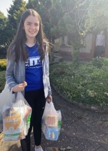 Poppy holding bags of shopping