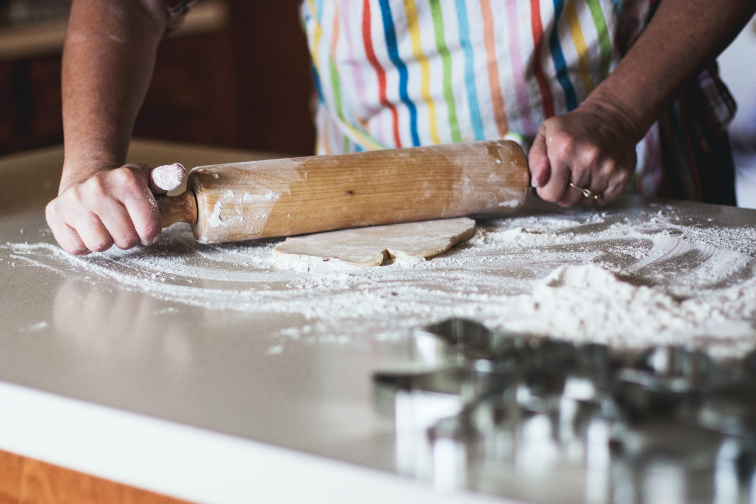 Someone baking using a rolling pin