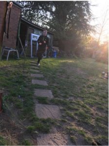 Young man running in garden