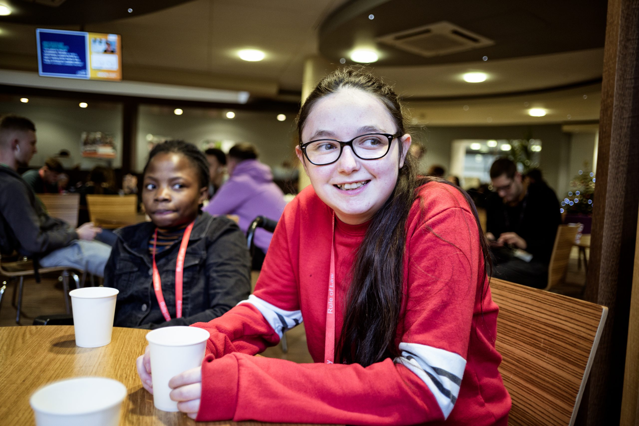 Happy smiling female teenager in red hoody