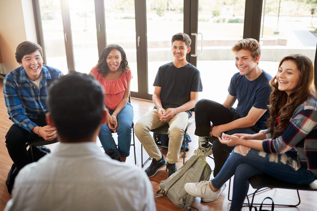 Group of diverse young pepe with teacher