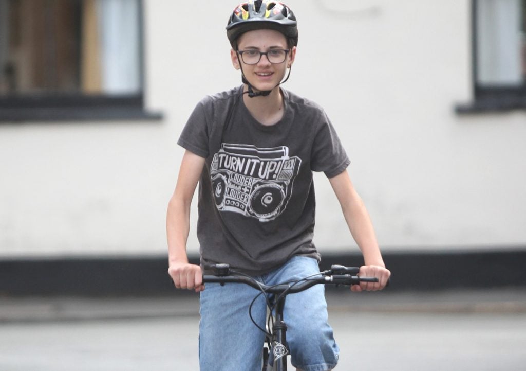 Frankie cycling with helmet for Physical section