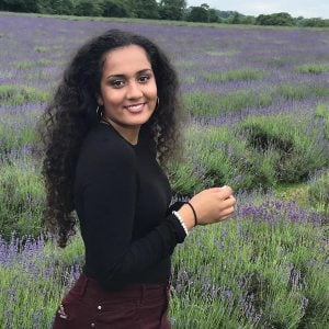 Girl standing in lavender field and smiling