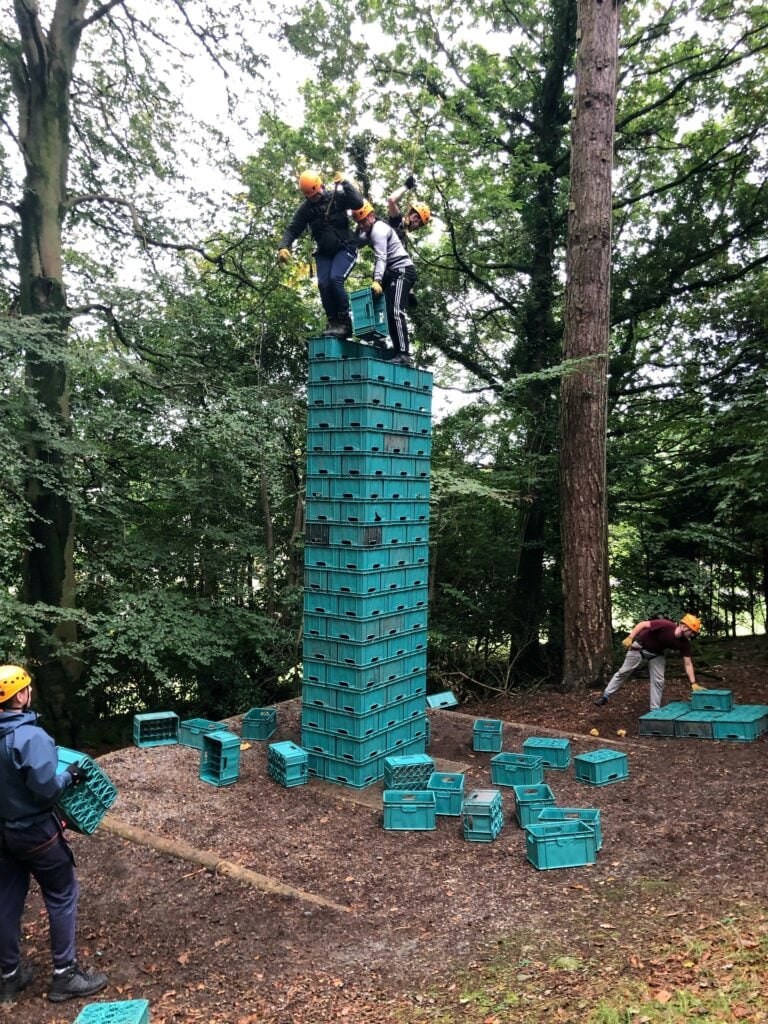 Team building exercise on green tower