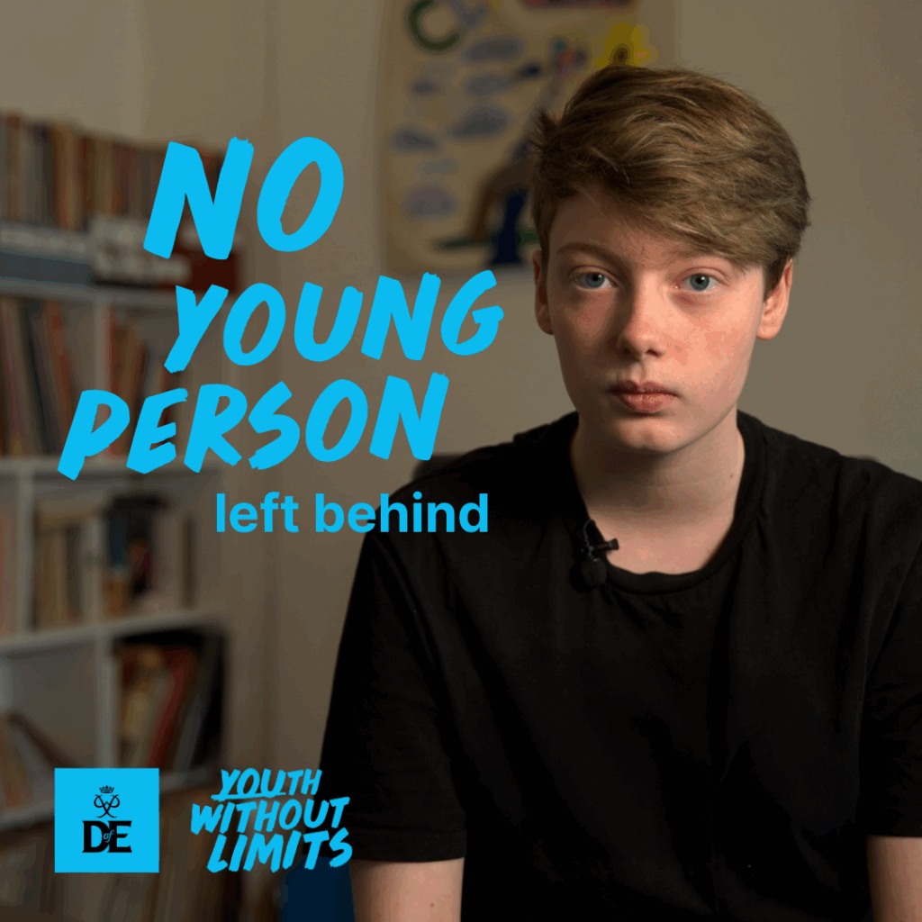 Ellesha has short light-brown hair and a black T-shirt, sits indoors in front of blurred bookshelves, looking calmly at the camera. Turquoise text on the left reads “NO YOUNG PERSON left behind,” with the DofE logo and “Youth Without Limits” beneath it.