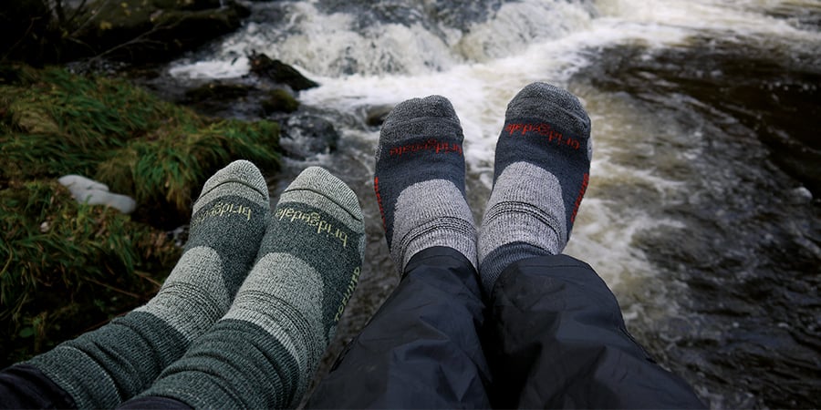 Two pairs of feet with Bridgedale socks on