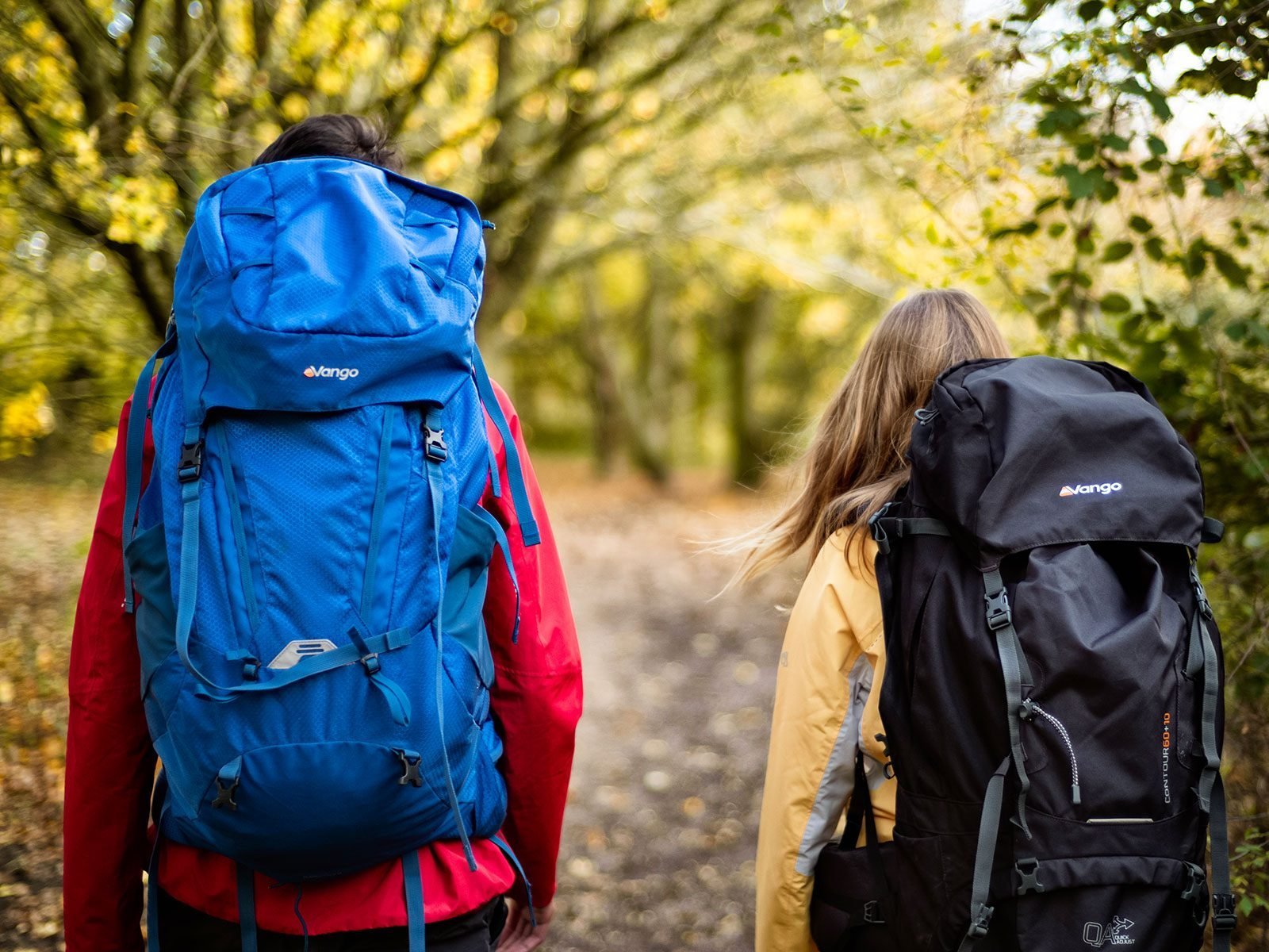 Two young people wearing Vango rucksacks