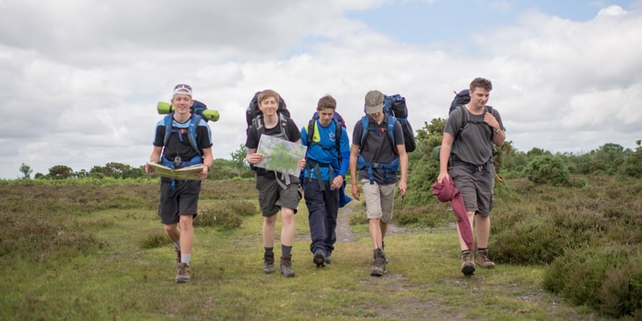Group of young people walking and reading a map