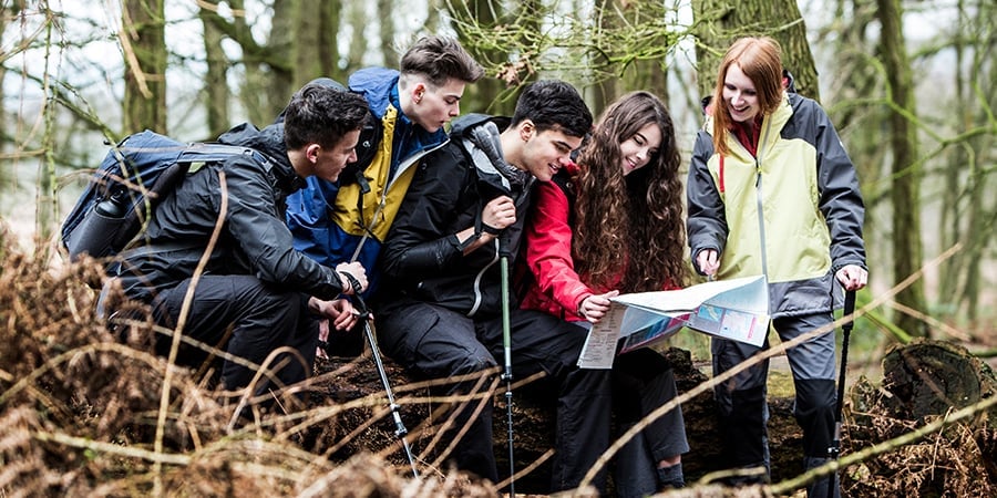 Group of young people reading a map