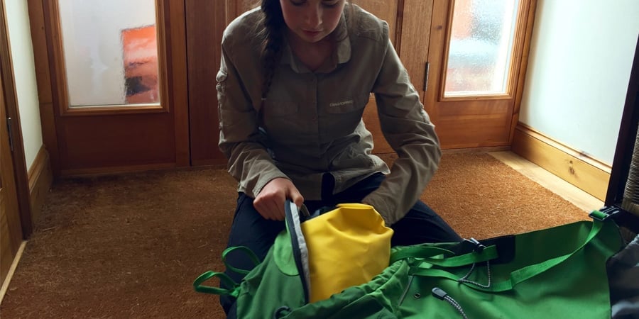 Young person packing a rucksack