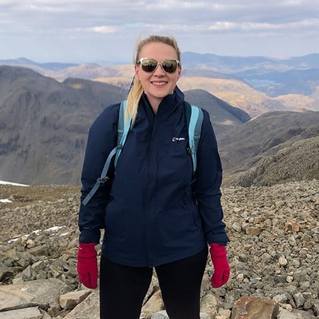 Young person on top of a mountain