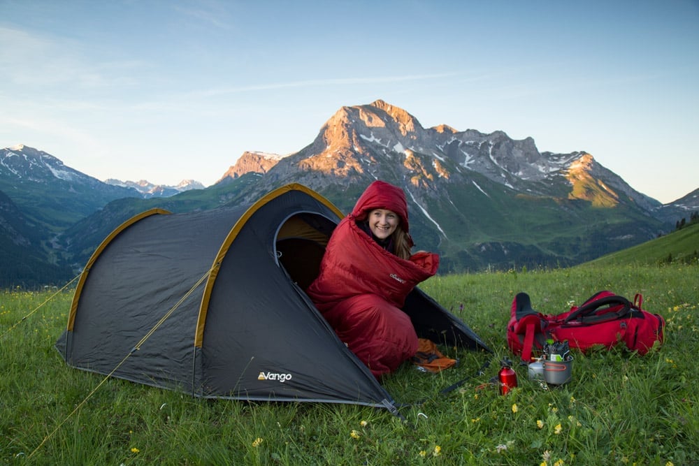 Young person in a sleeping bag and Vango tent