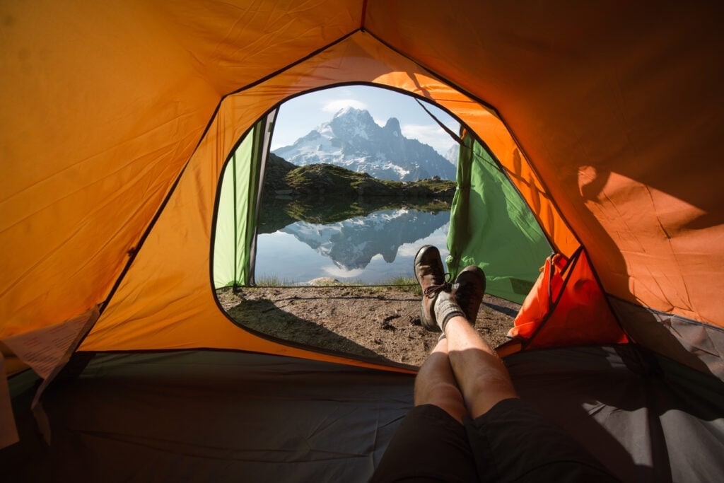 View of lake and mountain from inside a tent