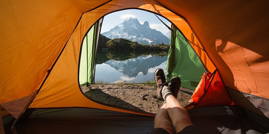 View of a lake and mountains from inside a tent