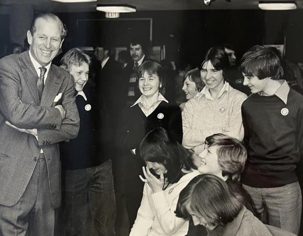 Black and white photo of HRH Prince Philip meeting DofE participants.