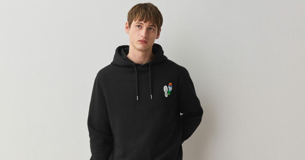 A young person wearing a black hoodie with the D of E at 70 logo on the chest.