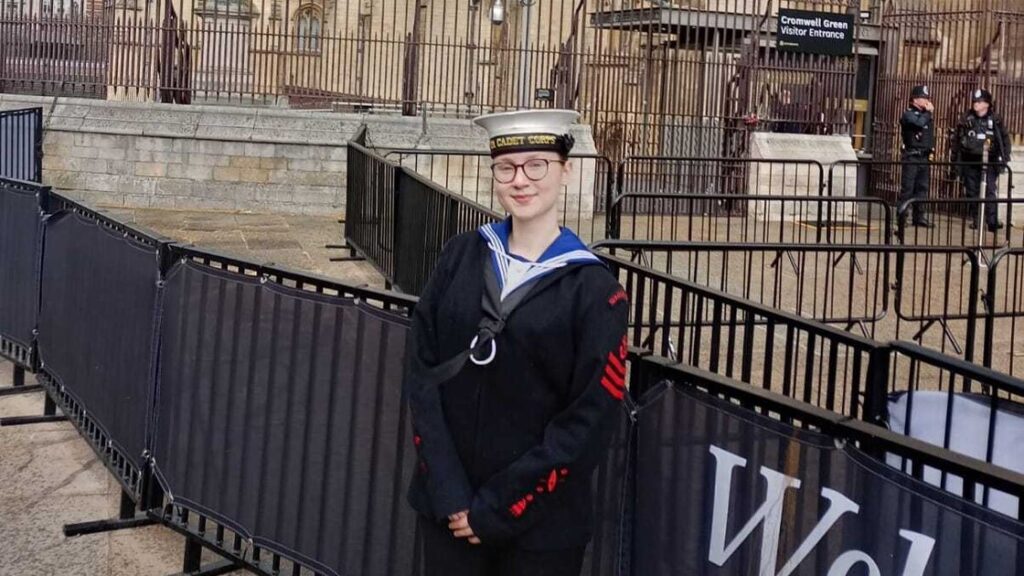 Megan is smiling, wearing a sea cadets uniform.