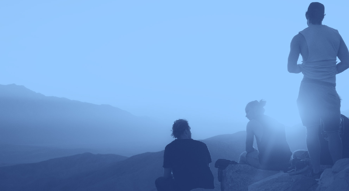 Group of people on mountain at sunset