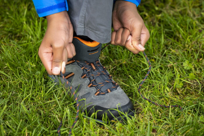 Someone tying a HI-TEC boot