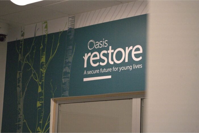A wall inside a building displays a sign that reads 