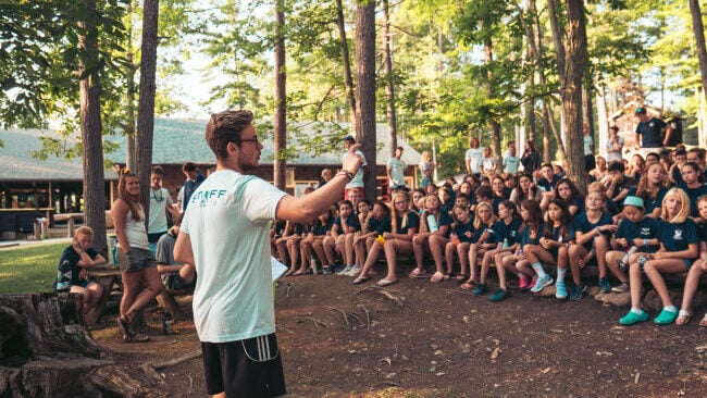 Camp Leader speaking to a group of young people