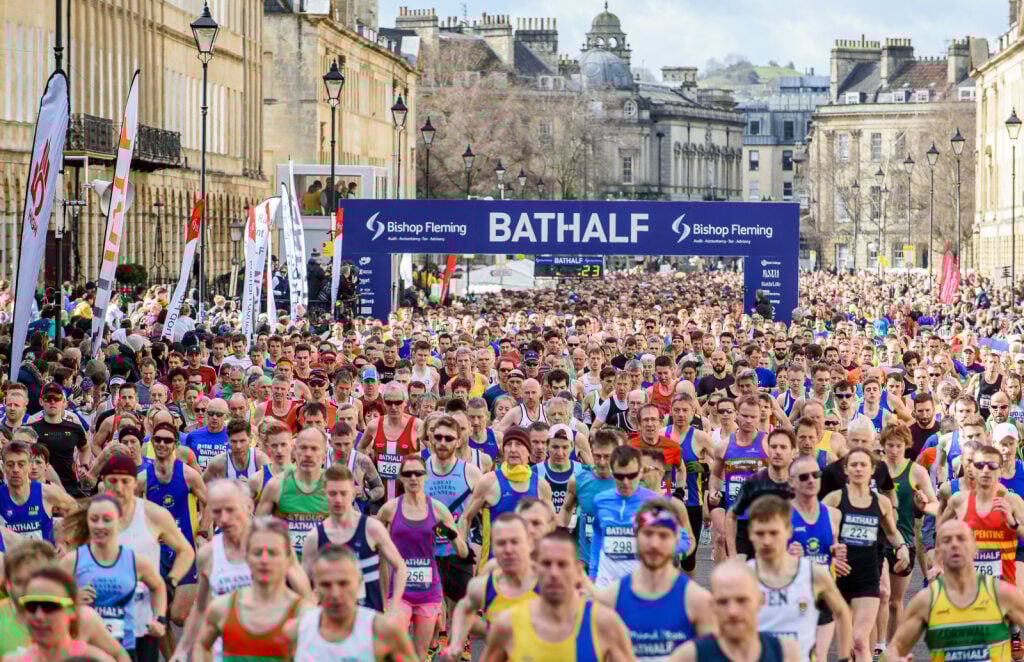 A crowd running in Bath with a starting line reading 
