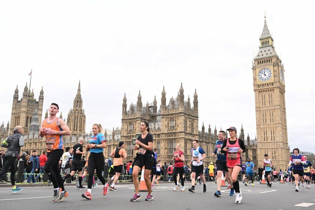 Half marathon runners passing Houses of Parliament and Big Ben