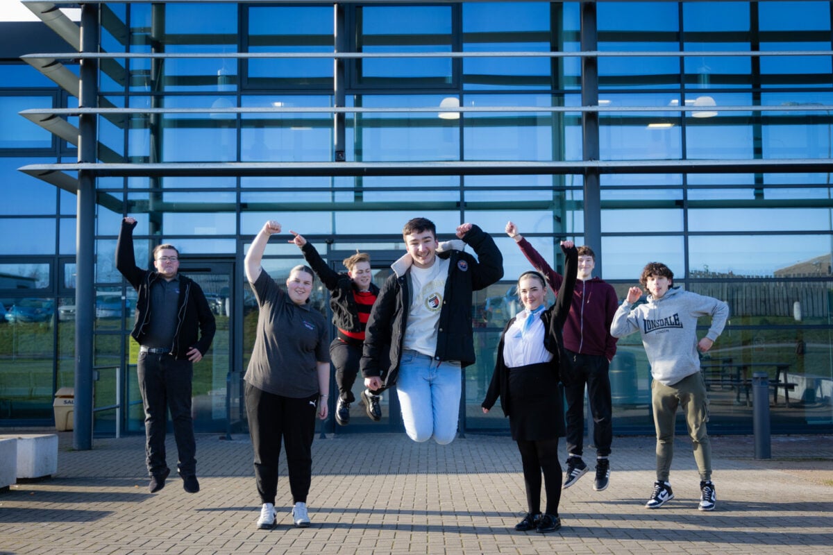 Group of young people jumping in the air.