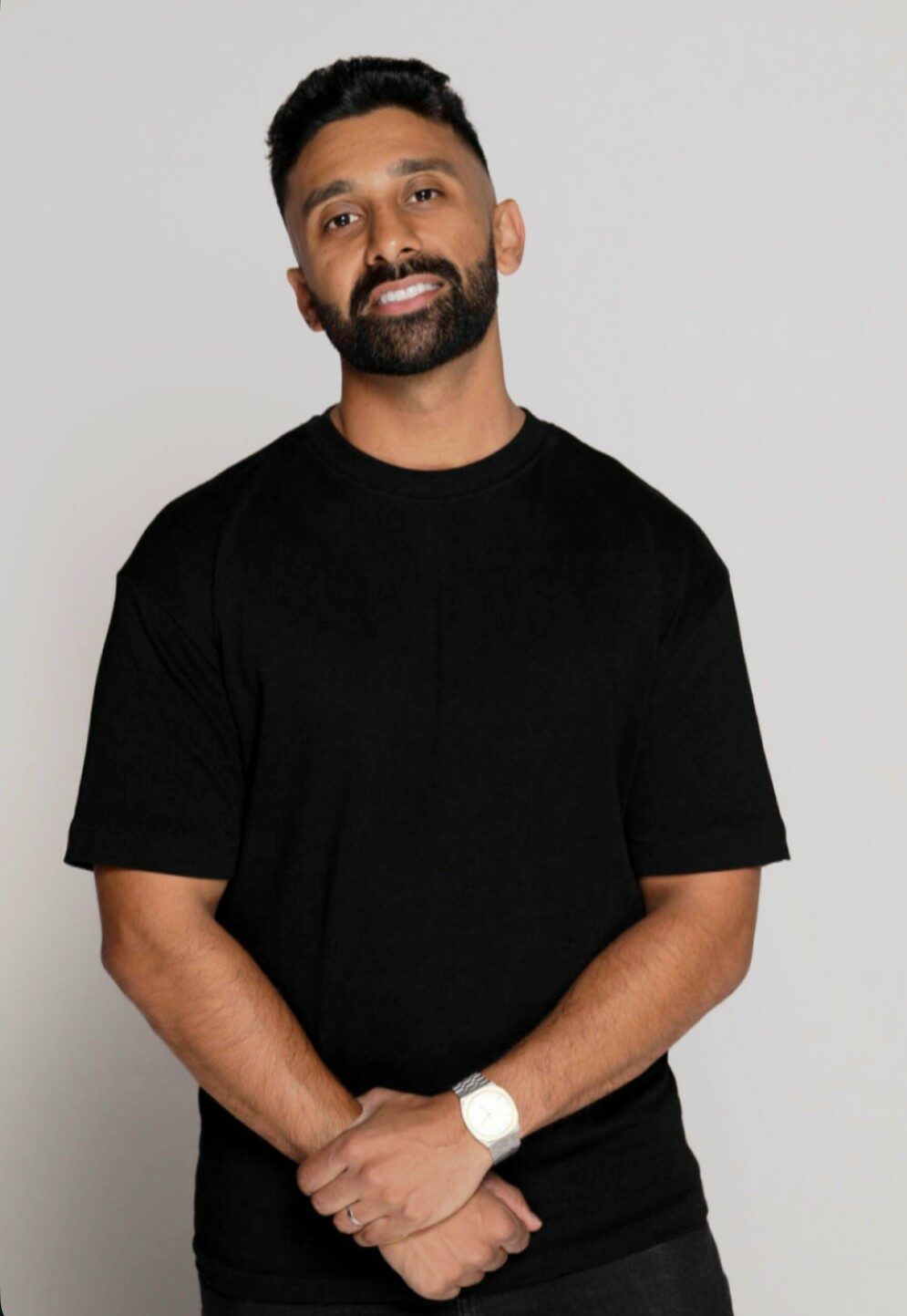 Jaz smiling and wearing a black tshirt.