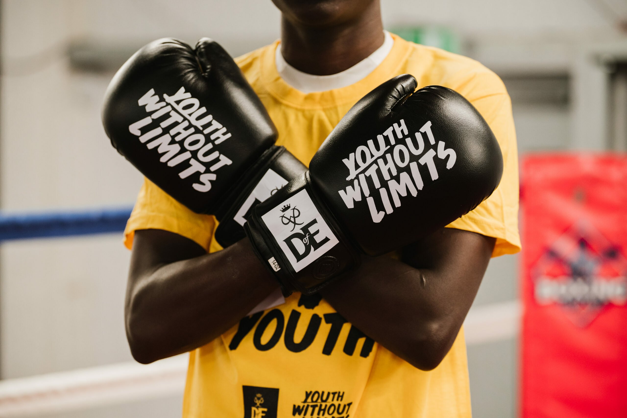 A person wearing a yellow t-shirt with the text 