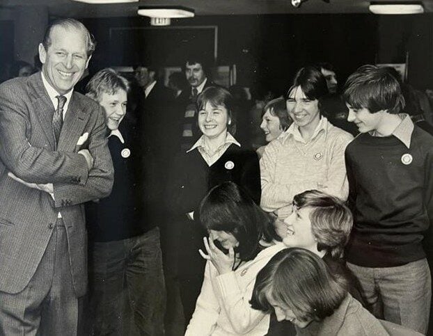 Black and white photo of HRH Prince Philip meeting DofE participants.
