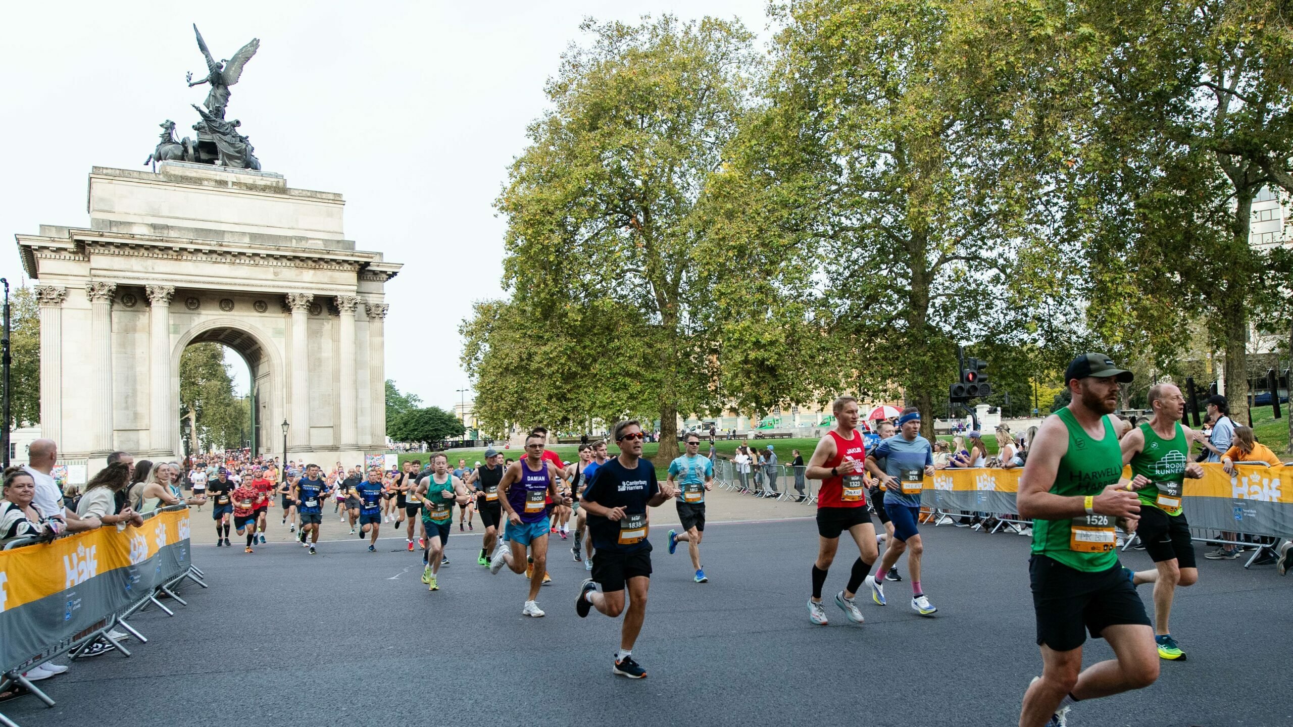 Half marathon runners passing Wellington Arch in London.