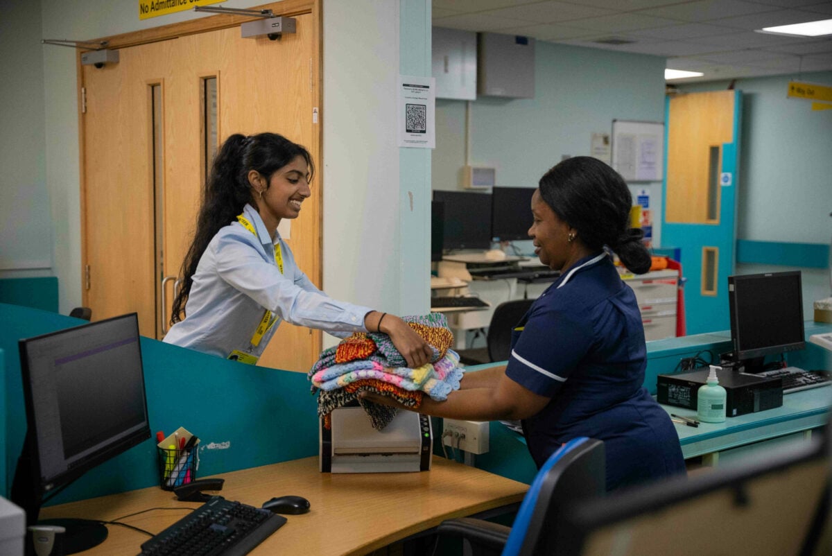 A DofE volunteer hands out care packages at Royal Berkshire Hospital,