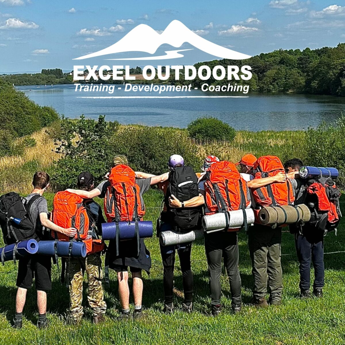 A group of young people on an expedition, looking at a scenic view of the country side. White logo at the top of the image says EXCEL OUTDOORS