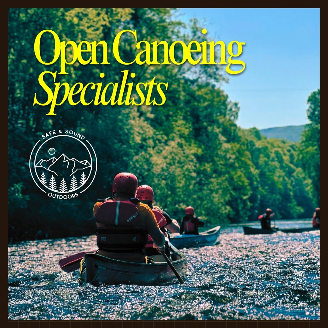 Canoeists paddling along a tree-lined river with the text “Open Canoeing Specialists” and the Safe & Sound Outdoors logo.