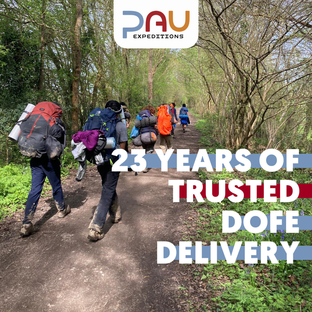 A group of DofE participants carrying large expedition backpacks walk along a woodland path surrounded by trees and greenery. The PAU Expeditions logo appears at the top of the image, with overlaid text reading: “23 years of trusted DofE delivery.”