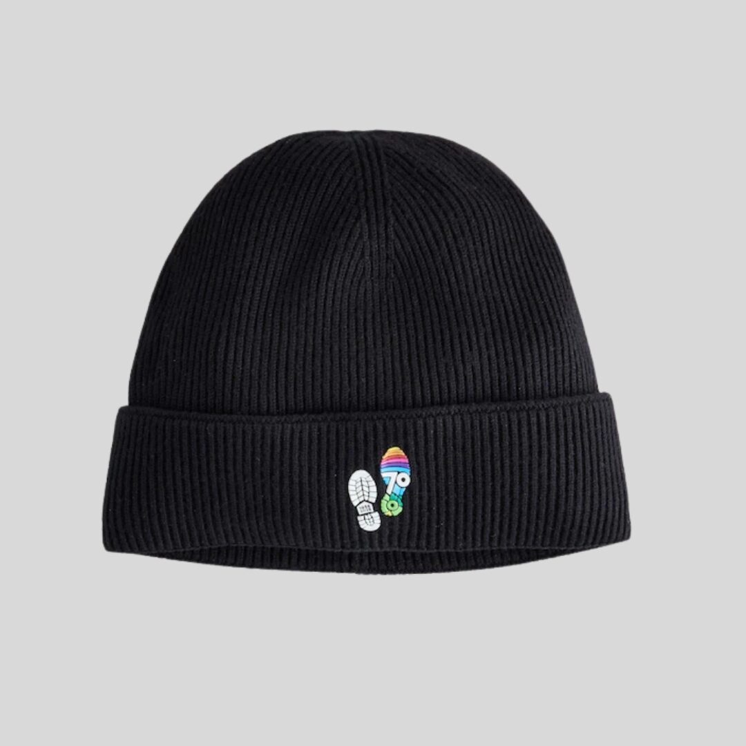 A black beanie hat with a small, multicoloured DofE 70 logo on the front. The logo is shaped like two footprints next to eachother.