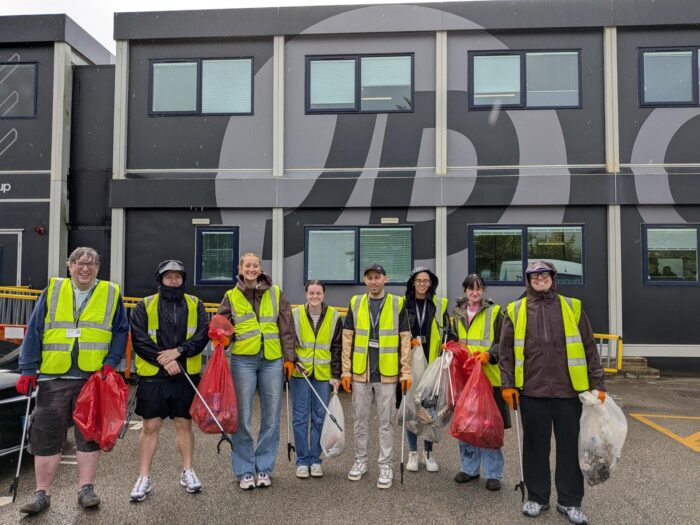 GO Outdoors colleagues with litter-picking equipment and collected rubbish outside the company head office.