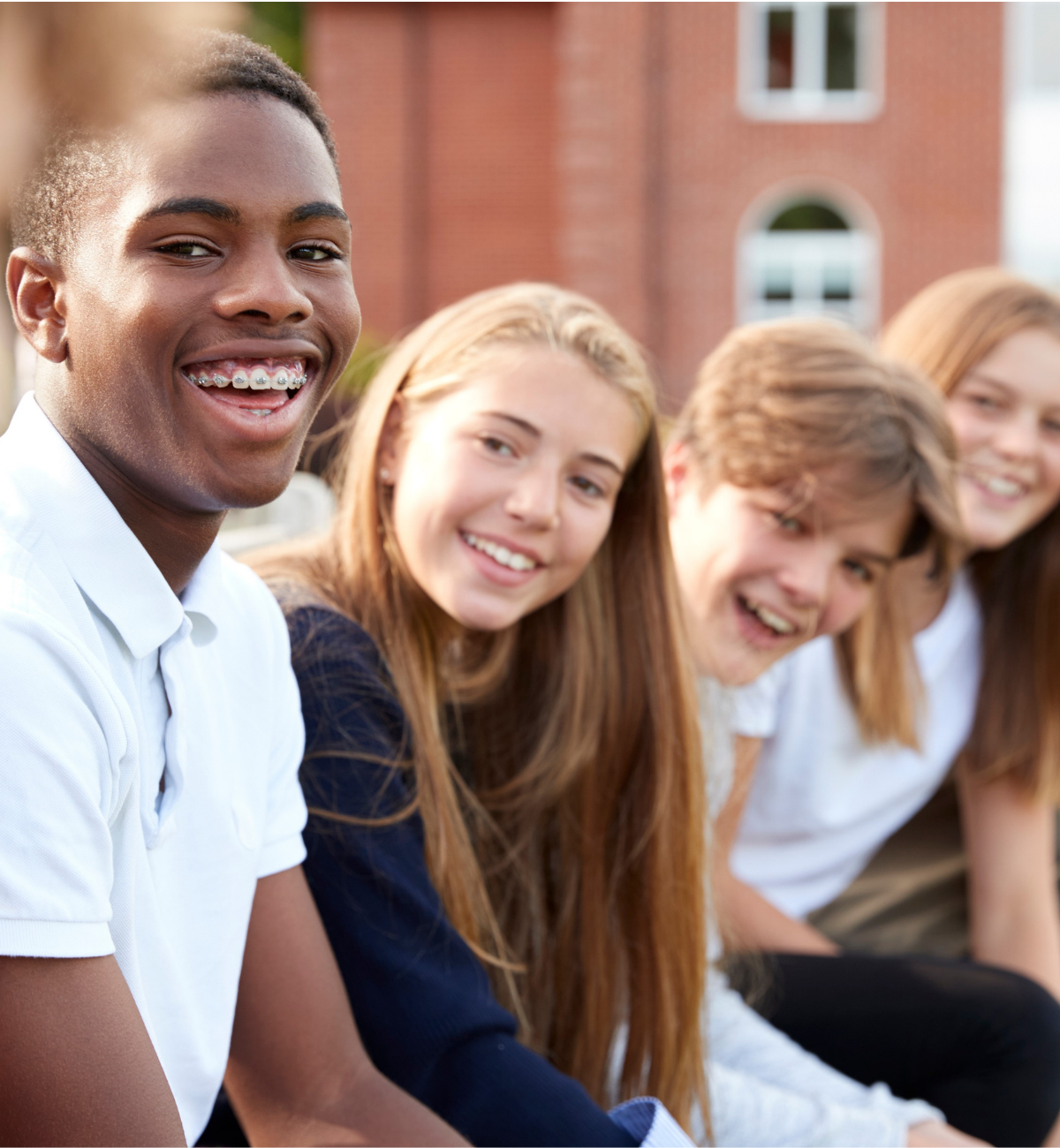 Group of smiling teens in a line