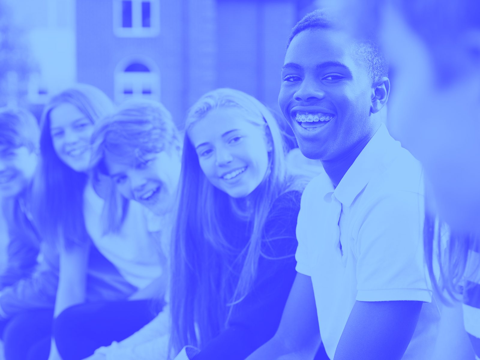 Group of young people smiling in a line