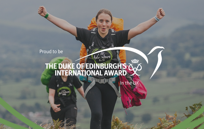 Young woman at top of hill with arms in the air celebrating, overlayed with text that says Proud to be The Duke of Edinburgh's International Award in the UK