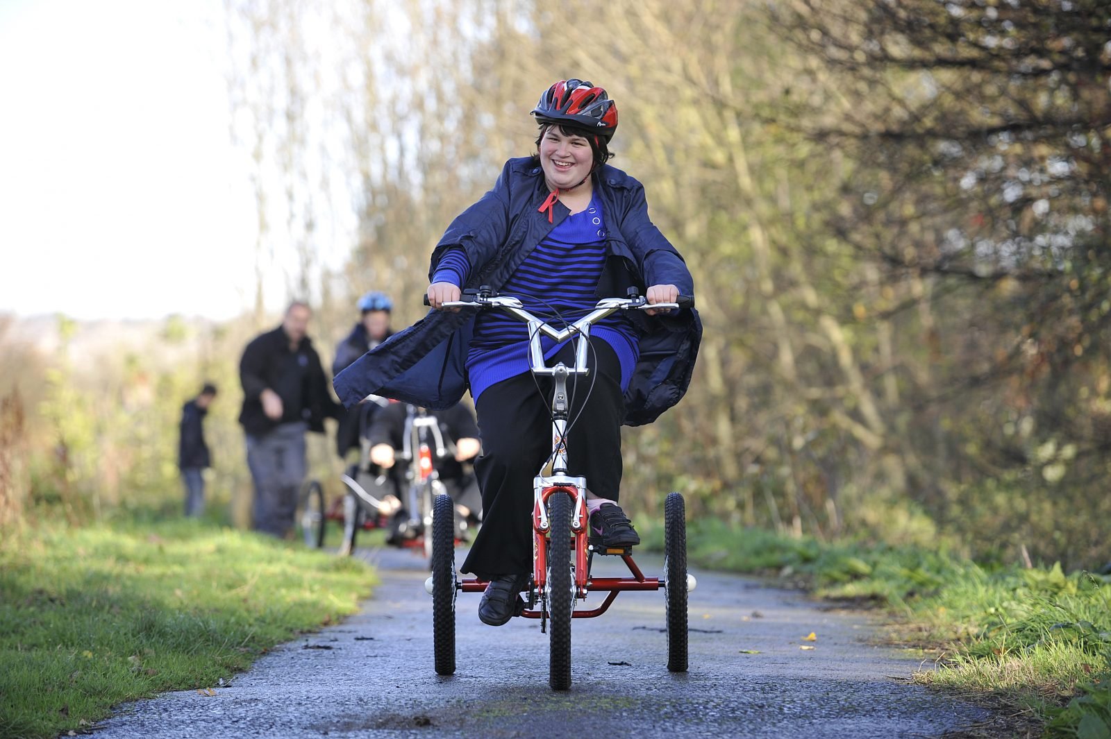 Young woman with additional needs cycling