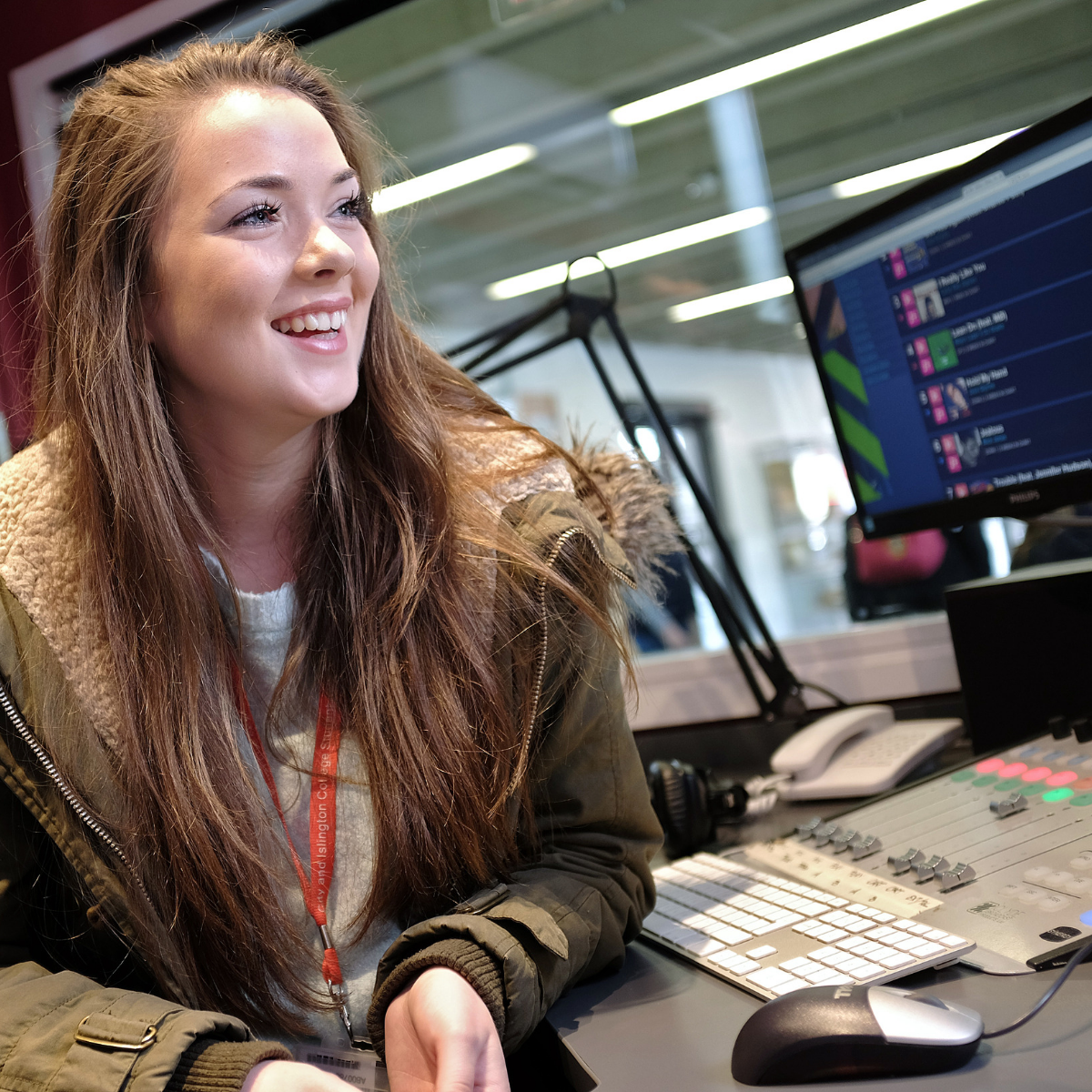 Girl doing DofE Skills section in radio station, sat in front of a sound mixer