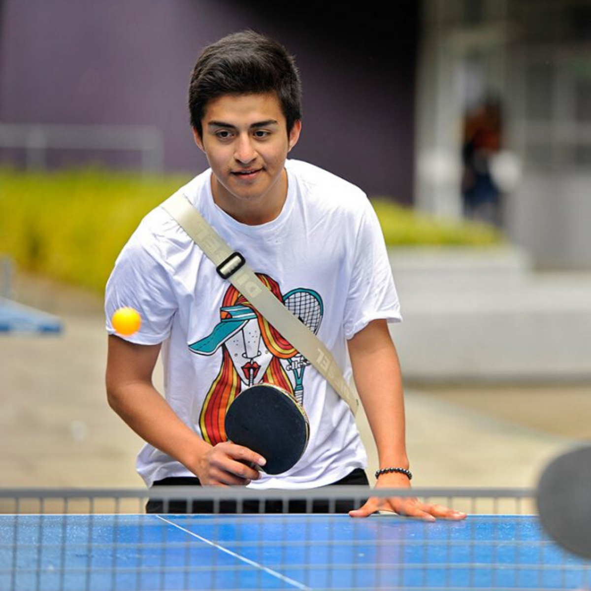 Two young men playing ping pong