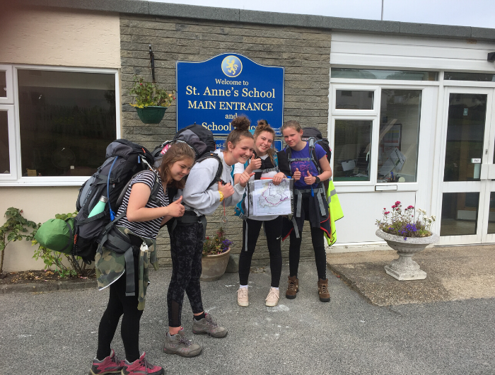 Four female pupils outside St Anne's school wearing rucksacks