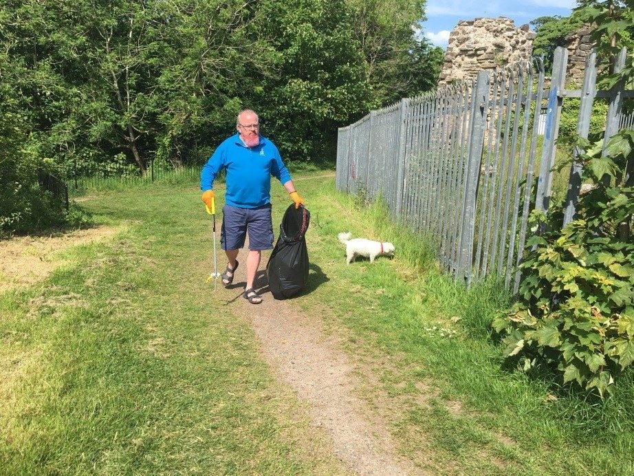 Kevin litter picking in blue shirt