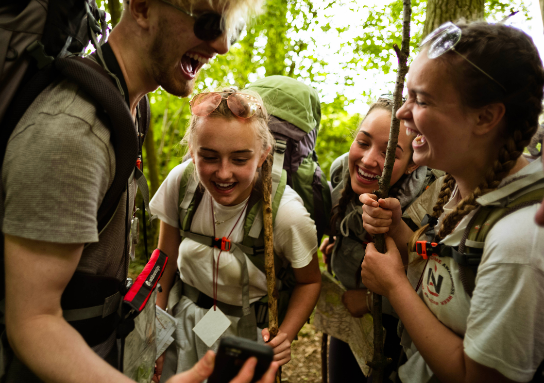 Group of young people on expedition laughing